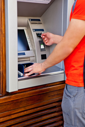 Man sticking card in ATM