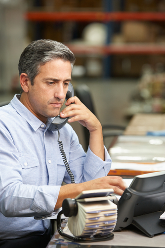 Man calling someone in rolodex